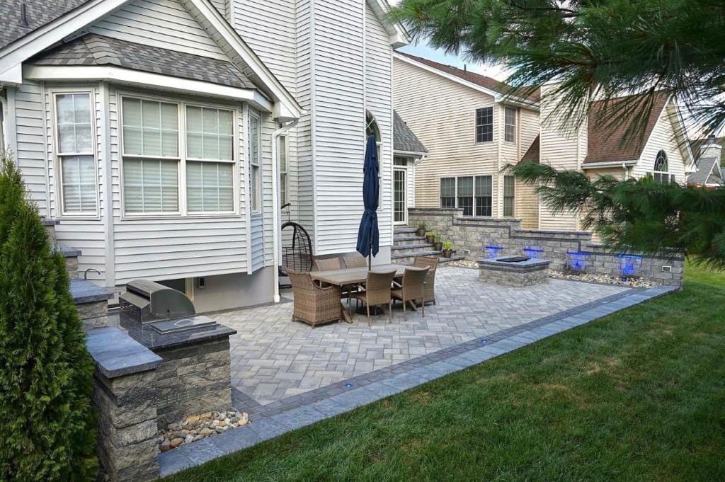 Paver patio with a seat wall and steps